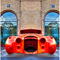Old Jaguar car body under reconstruction in front of Meilenwerk exhibition